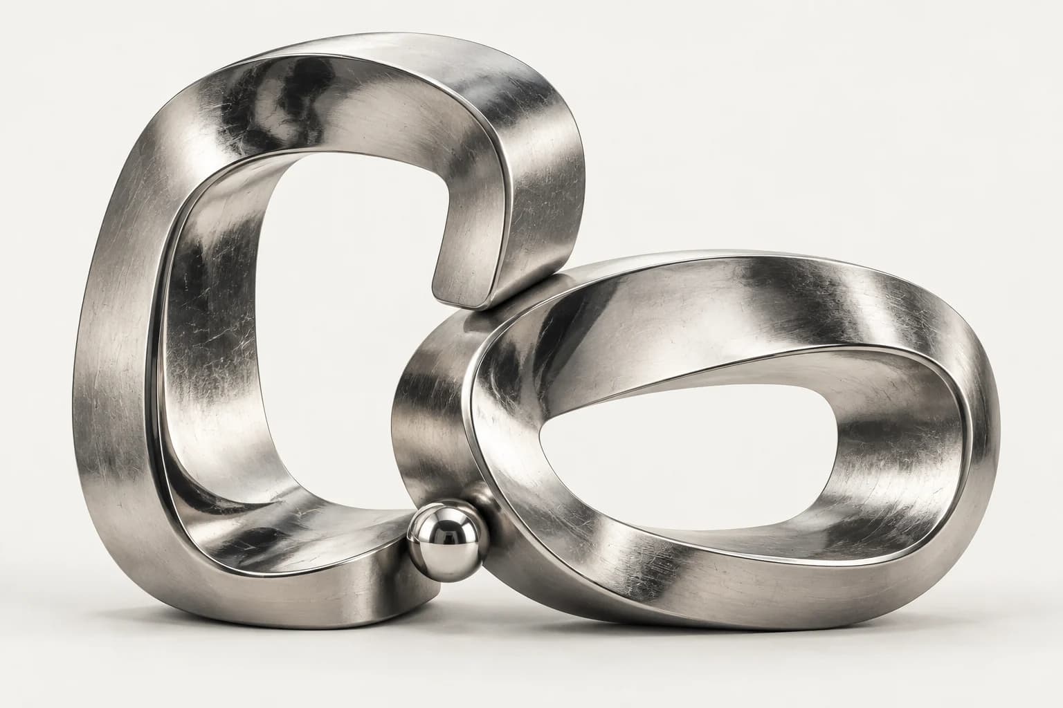 Two sculptural silver loops meeting to form a connection