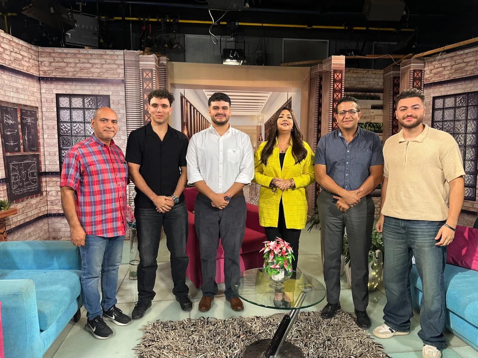 The Softworks team with the presenter and other people on the television set